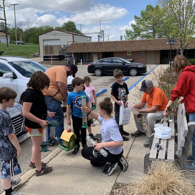 Members of the Fragrant Hilltoppers clean and fill bird feeders at Chapman Valley Manor