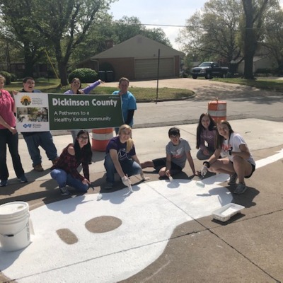 Abilene High School Students paint creative sidewalk in front of their school